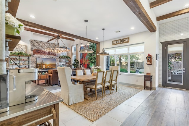 dining room featuring beamed ceiling, a notable chandelier, and light wood-type flooring