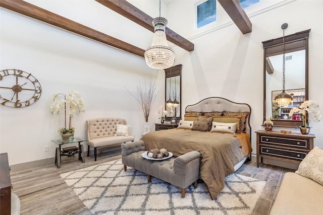 bedroom featuring hardwood / wood-style flooring and beam ceiling