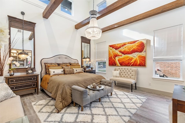 bedroom featuring a notable chandelier, beam ceiling, and wood-type flooring