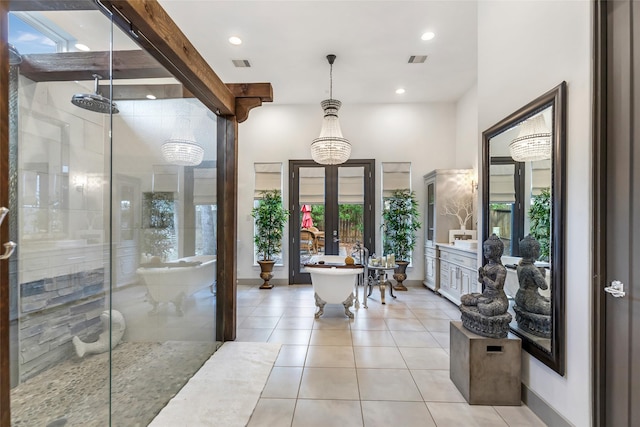 interior space featuring tile patterned flooring, a wealth of natural light, plus walk in shower, and french doors