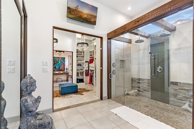 bathroom featuring a chandelier, tile patterned floors, and an enclosed shower