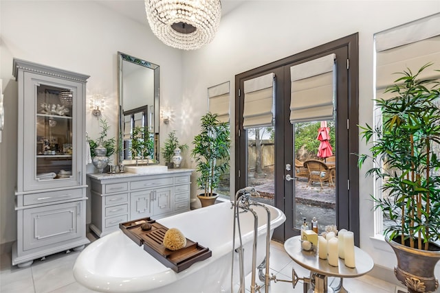 bathroom with vanity, a tub to relax in, and tile patterned flooring