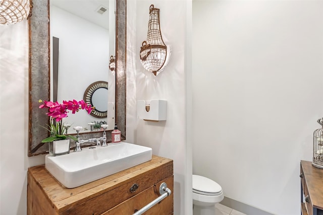 bathroom with vanity, tile patterned floors, and toilet