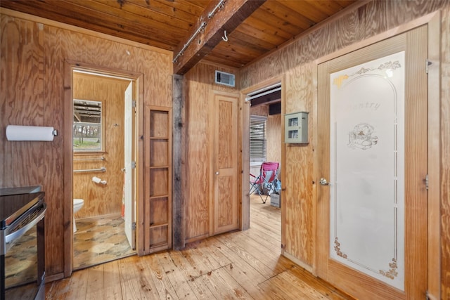 hall featuring beam ceiling, wood ceiling, light hardwood / wood-style flooring, and wooden walls