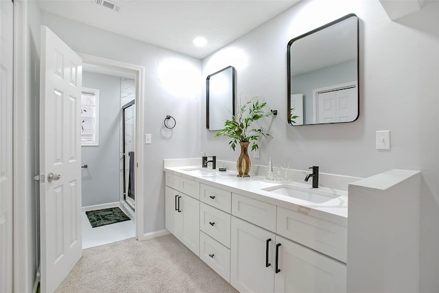 full bathroom featuring a stall shower, visible vents, a sink, and double vanity