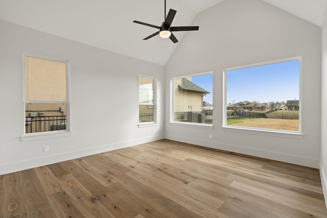 empty room with ceiling fan, baseboards, and wood finished floors