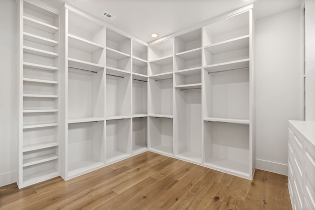 spacious closet with wood finished floors and visible vents