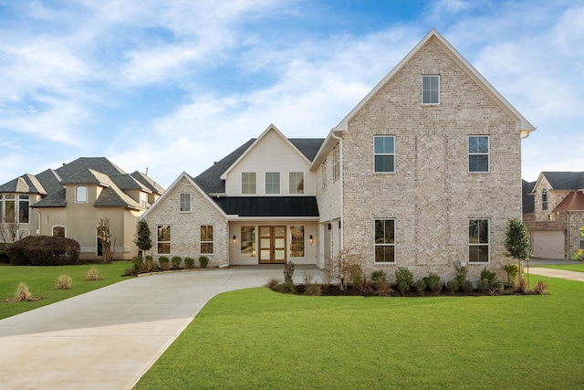 view of front of home featuring french doors, a front lawn, a standing seam roof, and brick siding