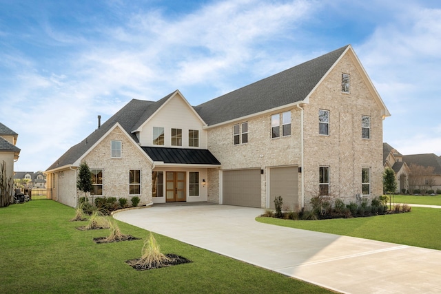 view of front of house featuring an attached garage, concrete driveway, french doors, a front lawn, and a standing seam roof