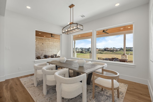 dining space featuring visible vents, baseboards, wood finished floors, and recessed lighting