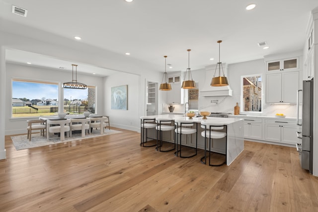 11585 Grandview Dr, Montgomery, TX 77356 - kitchen with recessed lighting, white cabinets, light countertops, an island with sink, and backsplash