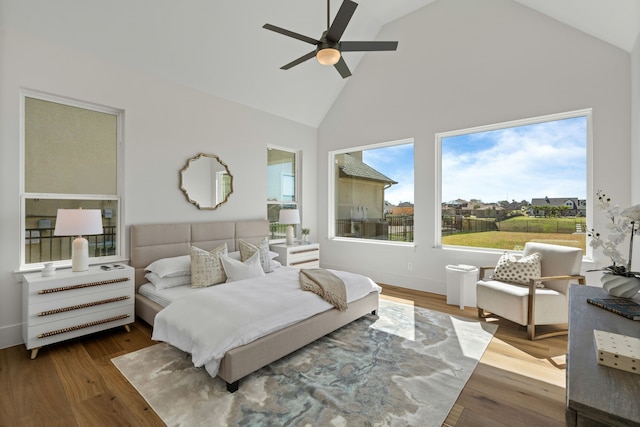 bedroom featuring ceiling fan, high vaulted ceiling, and wood finished floors