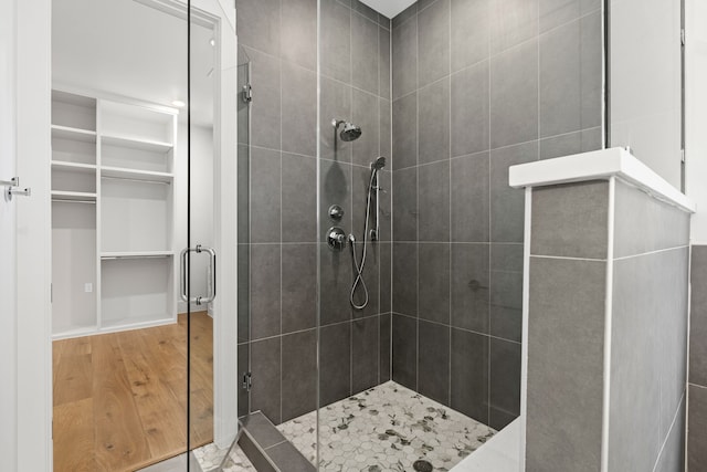 bathroom featuring a stall shower and wood finished floors