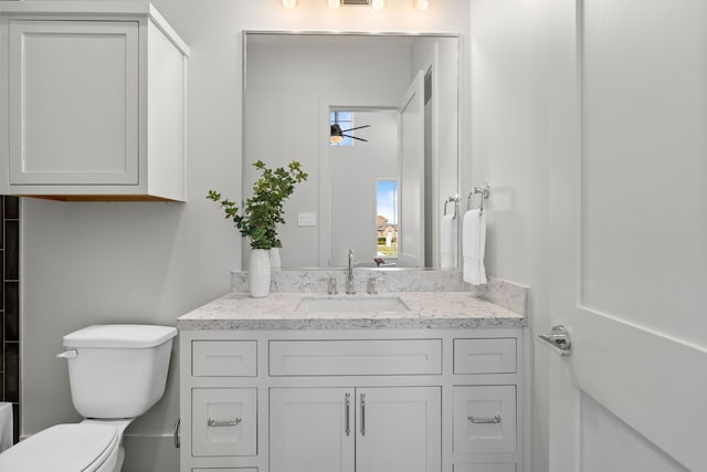 bathroom with ceiling fan, vanity, and toilet