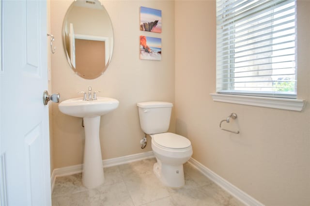 bathroom with tile patterned floors, toilet, and sink