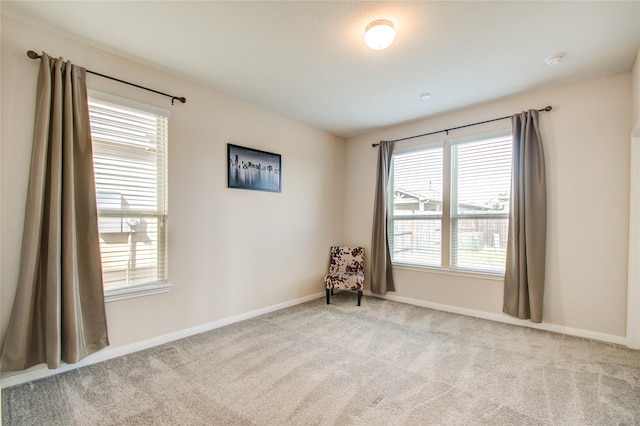 unfurnished room with light colored carpet