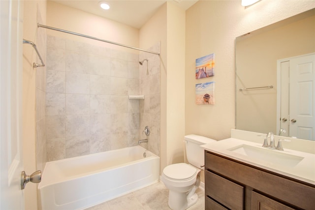 full bathroom featuring tile patterned flooring, tiled shower / bath, vanity, and toilet