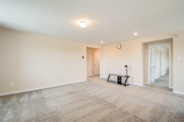 unfurnished room featuring light colored carpet