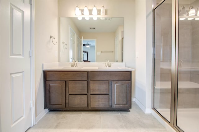 bathroom with tile patterned flooring, vanity, and walk in shower