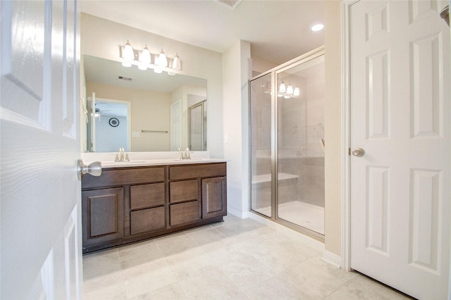 bathroom featuring walk in shower and vanity