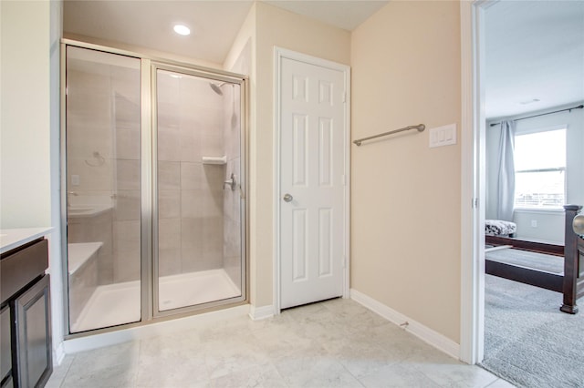 bathroom featuring vanity and an enclosed shower