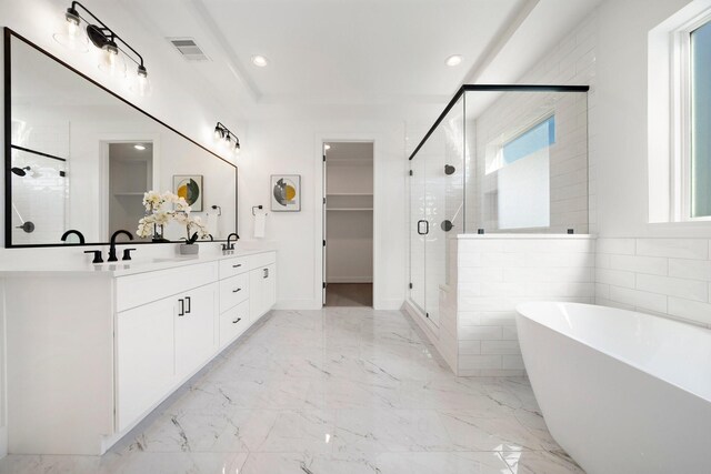 bathroom featuring plenty of natural light, shower with separate bathtub, and vanity