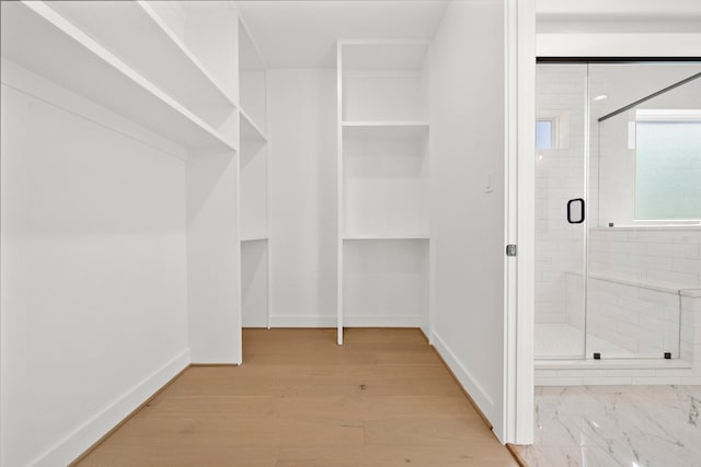 spacious closet with wood finished floors