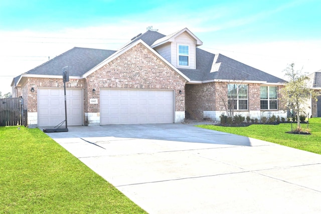 view of front of house featuring a garage and a front lawn