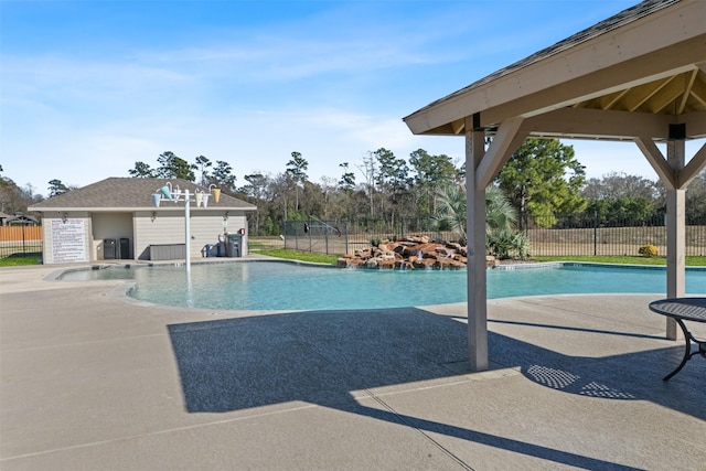 view of pool featuring a patio area, fence, and a gazebo