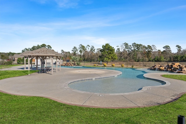 community pool featuring a gazebo, a yard, fence, and a patio area