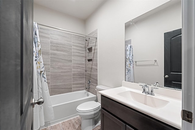 bathroom with toilet, shower / bathtub combination with curtain, wood finished floors, and vanity