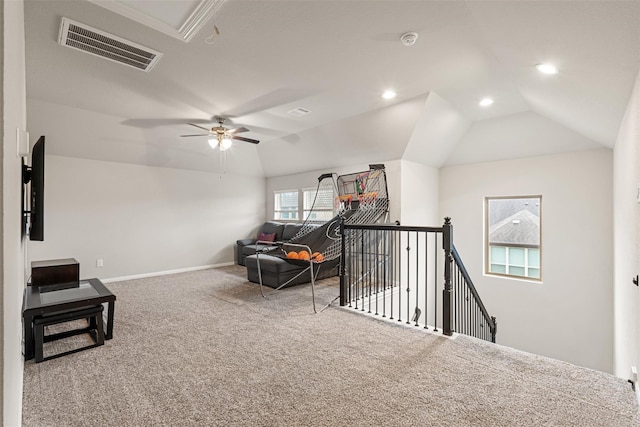 interior space with lofted ceiling, visible vents, carpet flooring, an upstairs landing, and baseboards