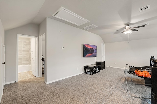 interior space featuring carpet floors, attic access, ceiling fan, and lofted ceiling