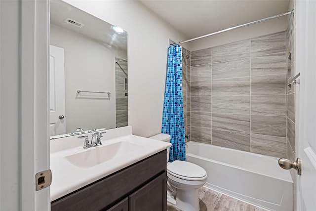 bathroom with visible vents, toilet, wood finished floors, shower / bathtub combination with curtain, and vanity