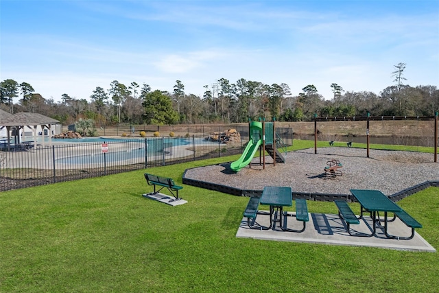 community play area with a community pool, fence, and a lawn