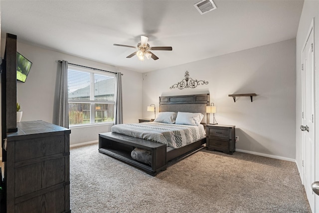 carpeted bedroom featuring ceiling fan, visible vents, and baseboards