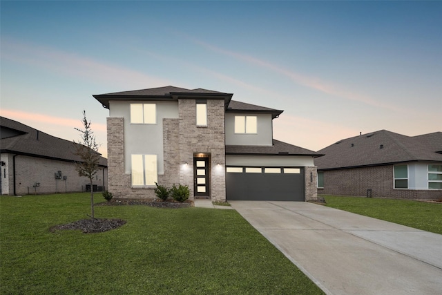 view of front of house with a yard and a garage