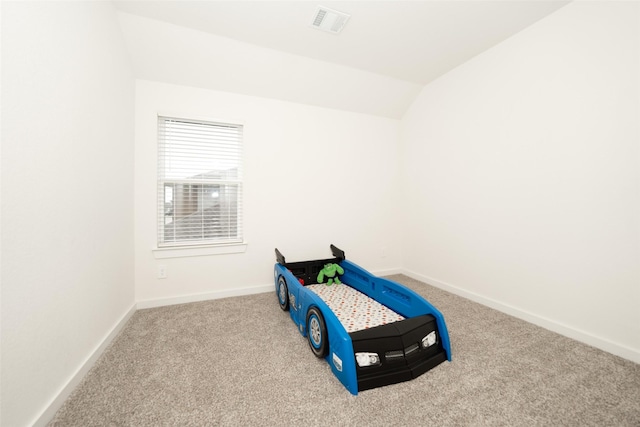 carpeted bedroom featuring vaulted ceiling