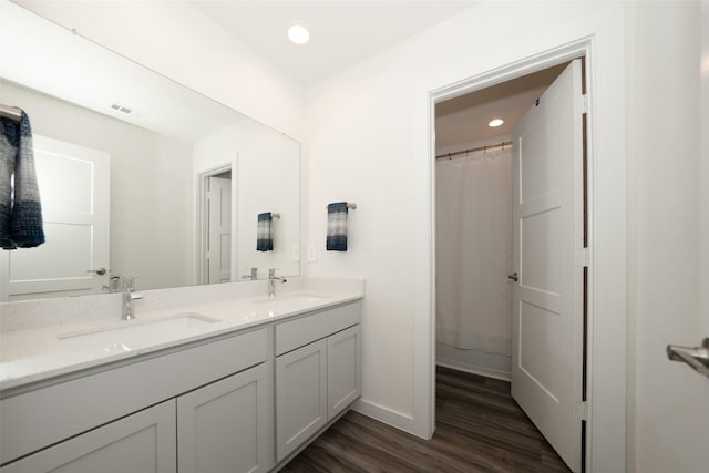 bathroom featuring vanity, wood-type flooring, and walk in shower