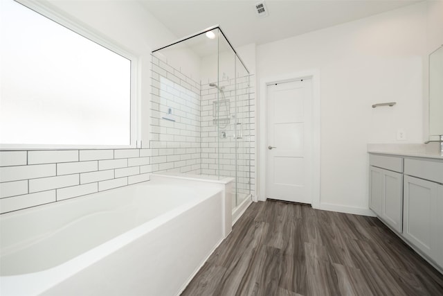 bathroom with vanity, wood-type flooring, and separate shower and tub