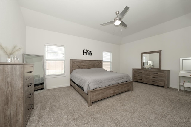 carpeted bedroom with multiple windows, vaulted ceiling, and ceiling fan