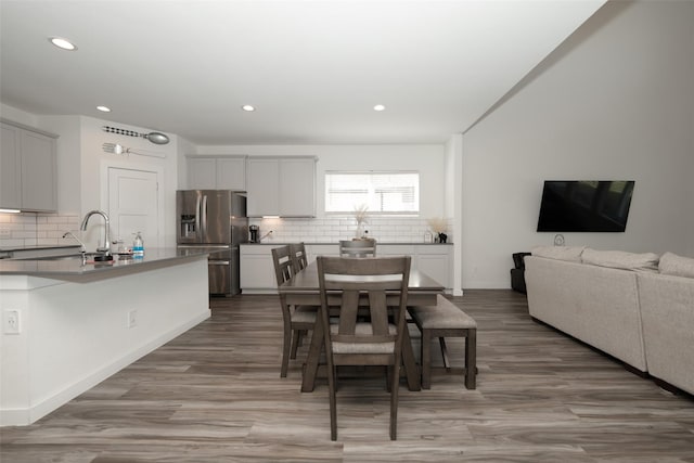 dining room featuring wood-type flooring and sink