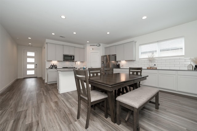 dining room featuring plenty of natural light and light wood-type flooring