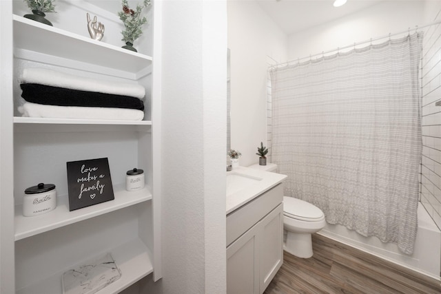 full bathroom with vanity, toilet, hardwood / wood-style floors, and shower / bath combo with shower curtain