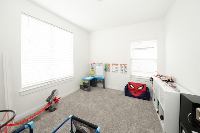 rec room featuring a healthy amount of sunlight and light carpet