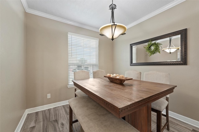 dining space featuring hardwood / wood-style flooring and ornamental molding