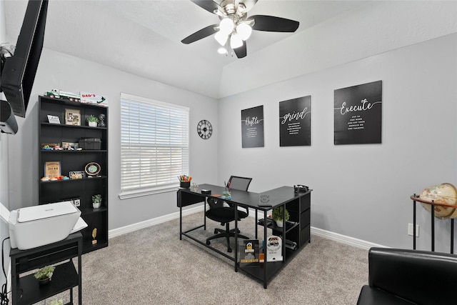 carpeted office space featuring vaulted ceiling and ceiling fan