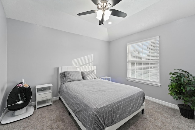 carpeted bedroom with ceiling fan and vaulted ceiling