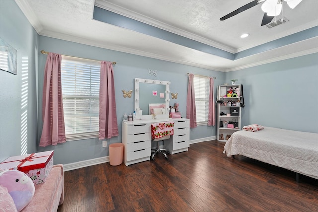 bedroom featuring dark hardwood / wood-style flooring, crown molding, a raised ceiling, and ceiling fan