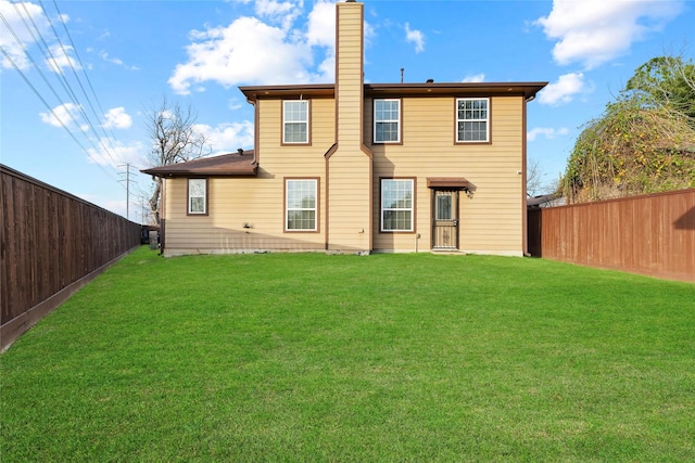 back of house featuring a yard